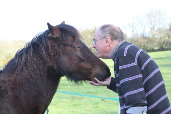 Anna Thomas Monty Roberts Instructor man touching horse's head